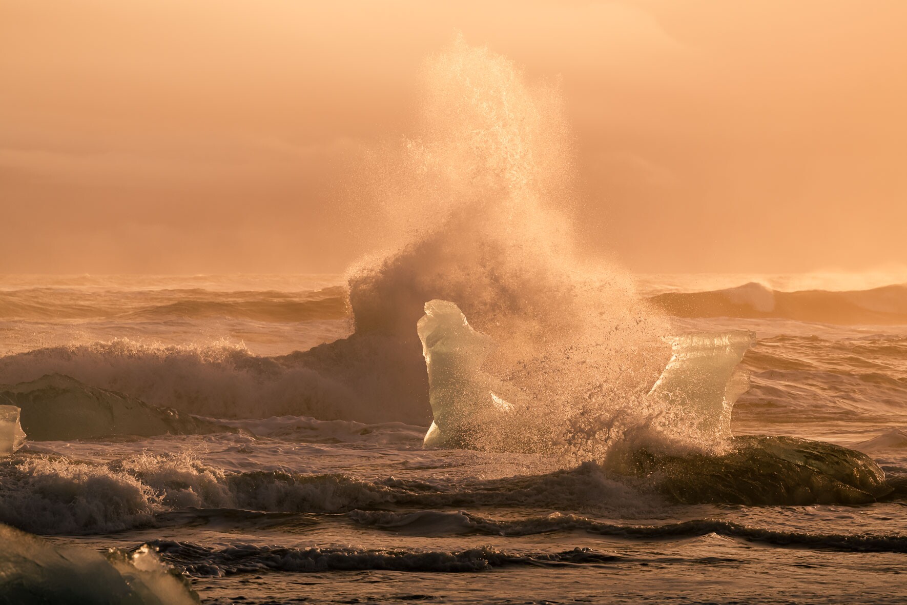 Sunset over Crashing Waves and Icebergs at Diamond Beach in Iceland