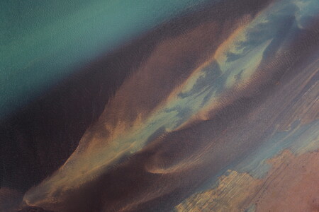 Colorful aerial view of a glacial river in Iceland with sandbanks