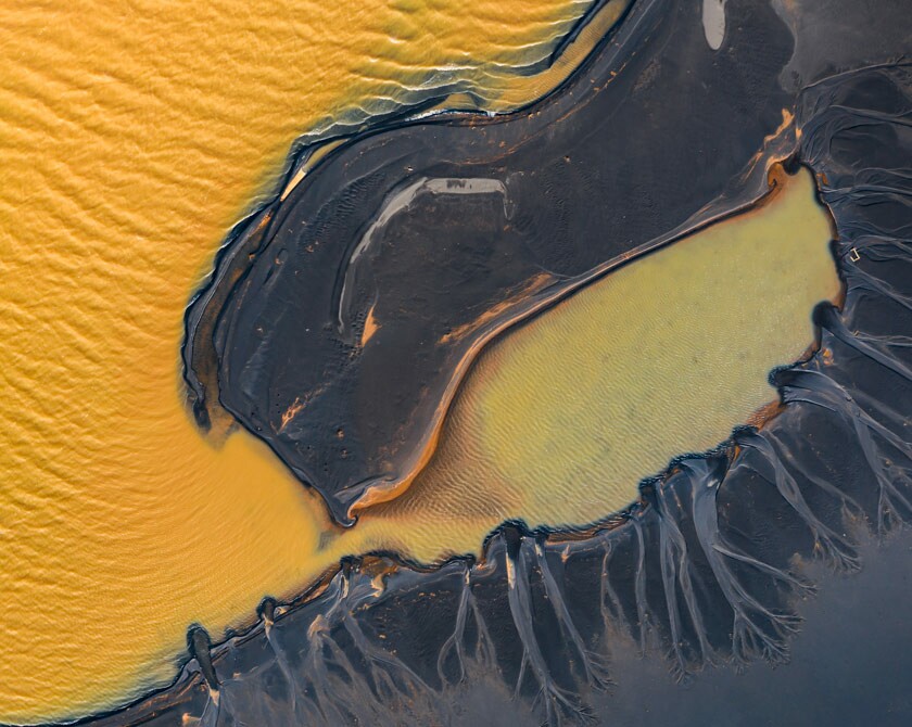 Aerial photograph of yellow lake with black sand