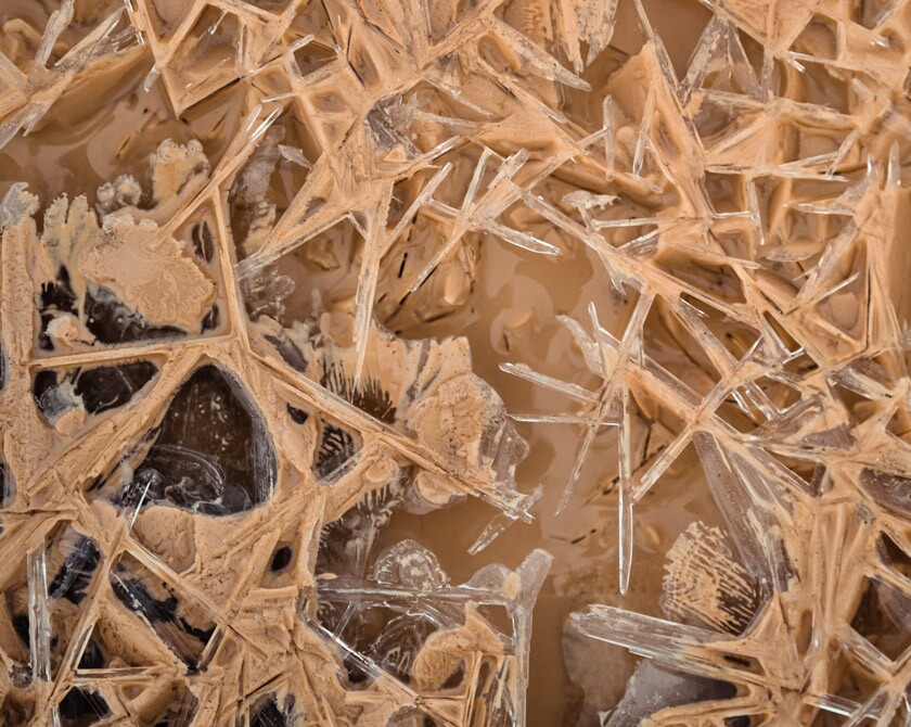 Abstract macro photography of ice crystals in a frozen creek