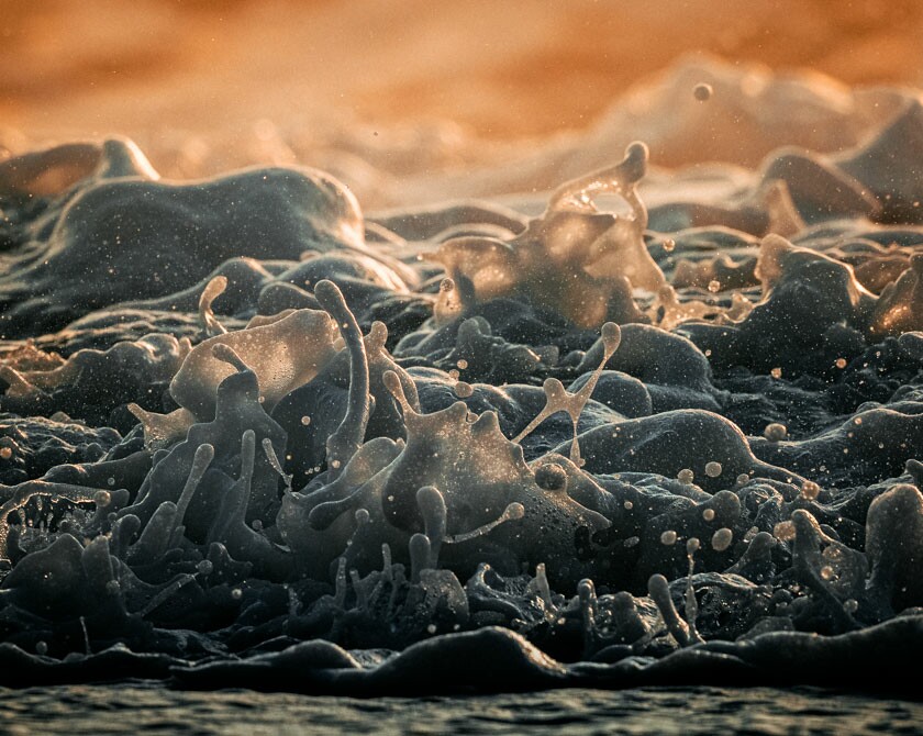 Close-ups of Splashing Waves in Warm Sunset Colors