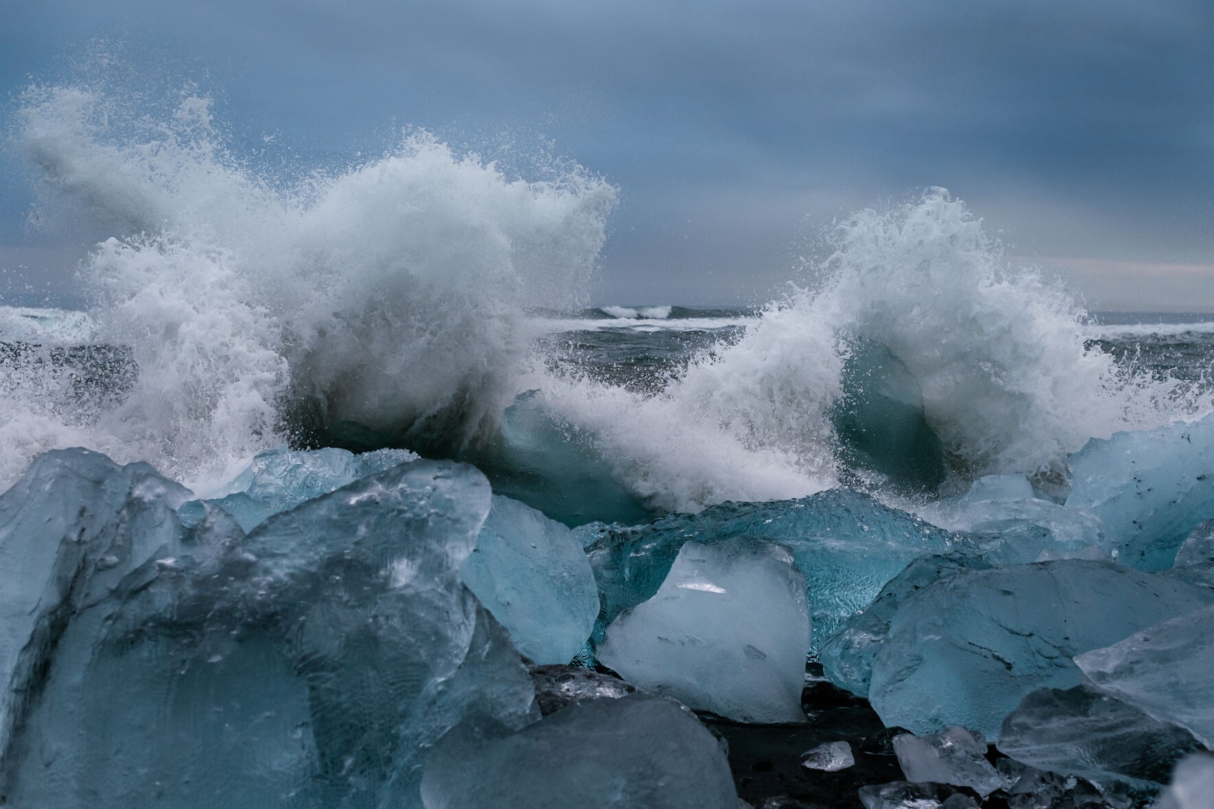 Waves Crashing at Icebergs on Diamond Beach near Jökulsárlón Glacier Lagoon