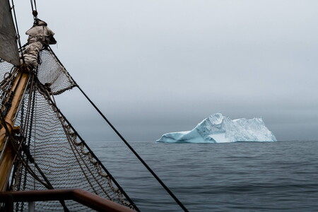 Tall ship Bark Europa and iceberg in Antarctic waters