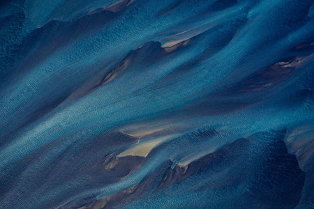 Aerial photography of Holsa river on the south coast of Iceland with small sandbanks and seagulls