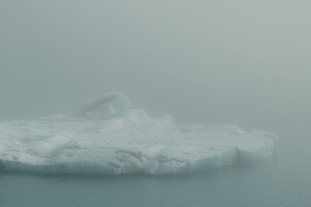 Iceberg in Jökulsárlón glacier lagoon in Iceland surrounded by dense sea fog