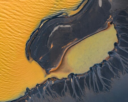 Aerial photograph of yellow lake with black sand