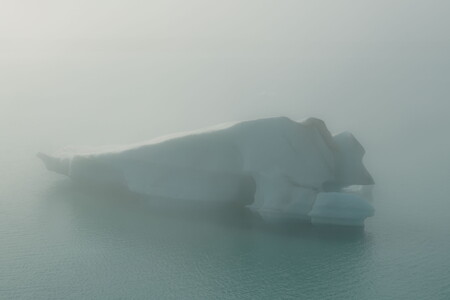 Iceberg in Jökulsárlón glacier lagoon surrounded by dense fog and soft light