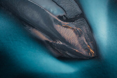 Aerial photography of glacier river with small island in Iceland