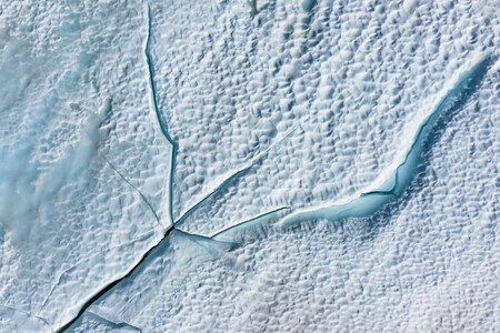 Cracks in the surface of a snow-covered and frozen lake in Norway