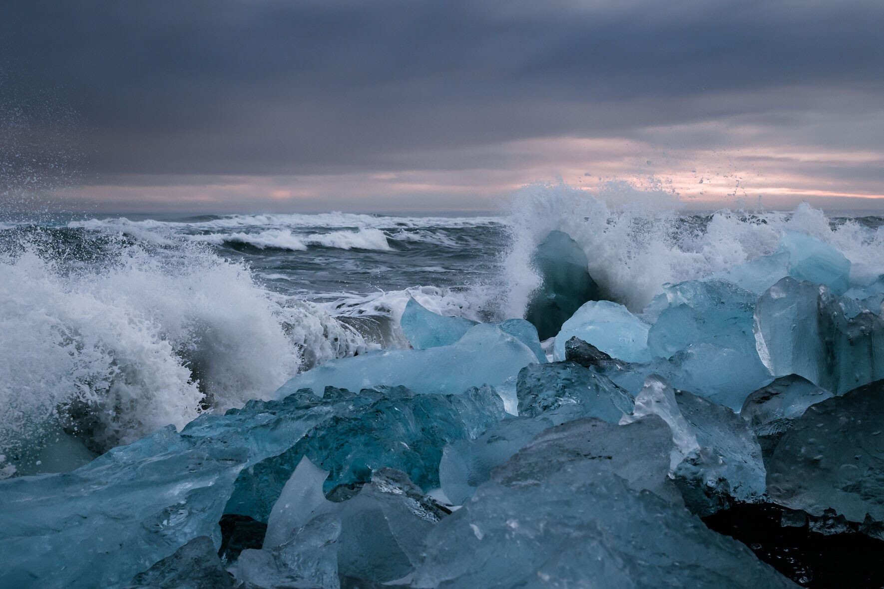 Waves Crashing at Icebergs on Diamond Beach near Jökulsárlón Glacier Lagoon