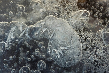 Frozen air bubbles trapped under the ice a frozen lake in southern Norway