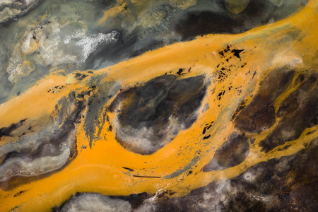 Surreal Aerial Winter Landscape of Iceland with Orange River and Black Sand