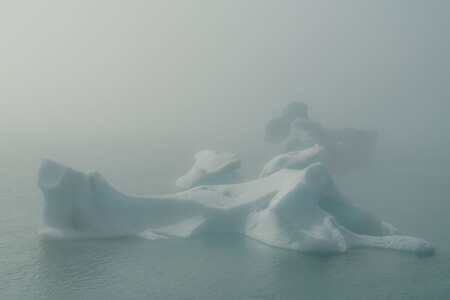 Icebergs in Jökulsárlón glacier lagoon in Iceland surrounded by dense fog in summer