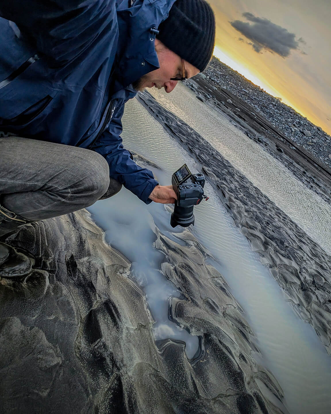Jan Erik Waider photographing glacial river sediments in Iceland.