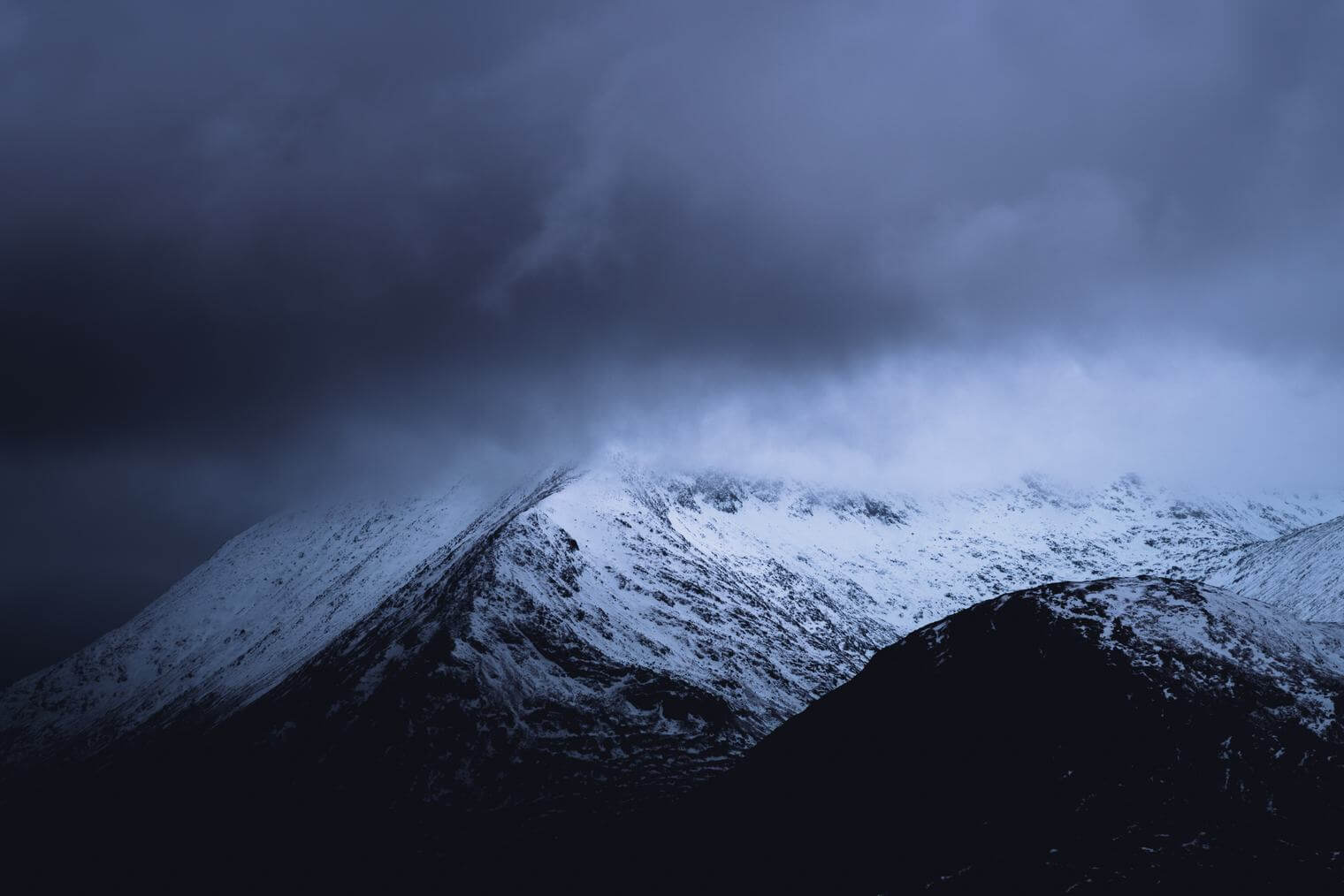 Moody mountains of Scotland with snow