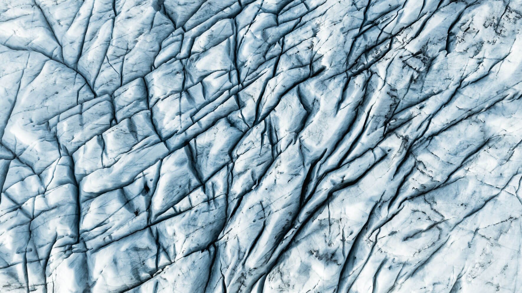 Close-up aerial view of the Vatnajokull glacier with black ash by Northlandscapes