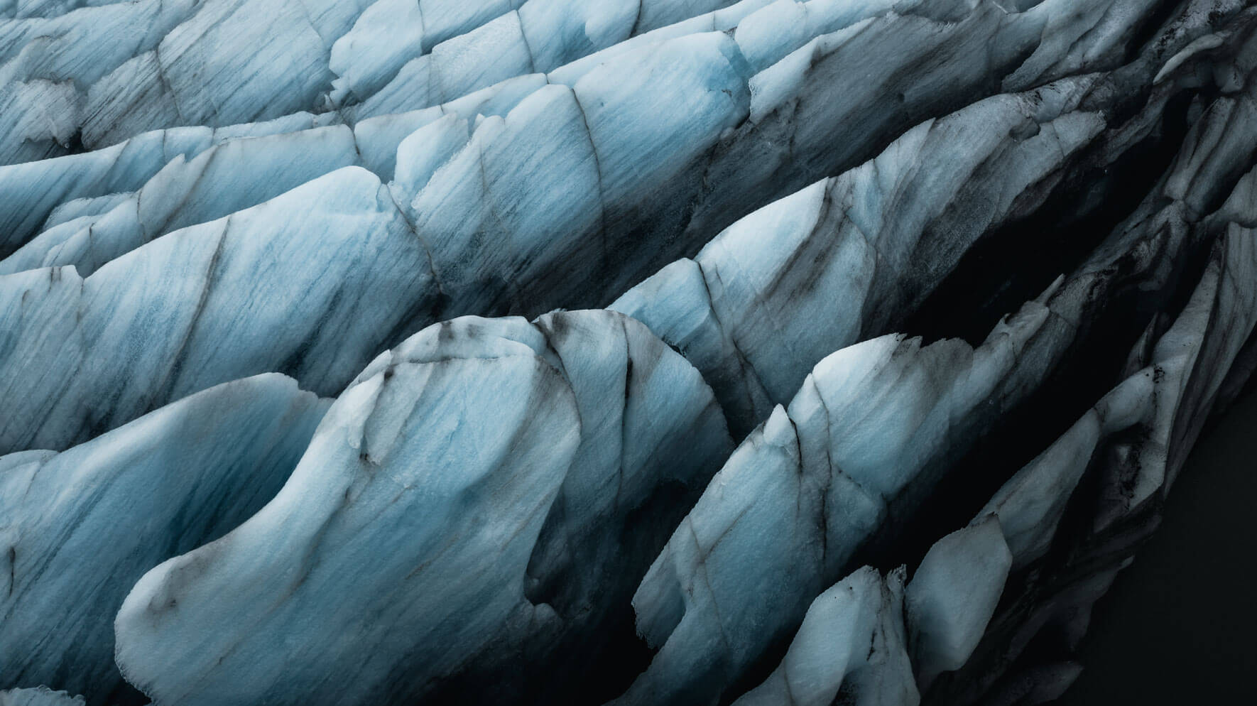 Close-up aerial view of the Svínafellsjökull glacier with volcanic ash