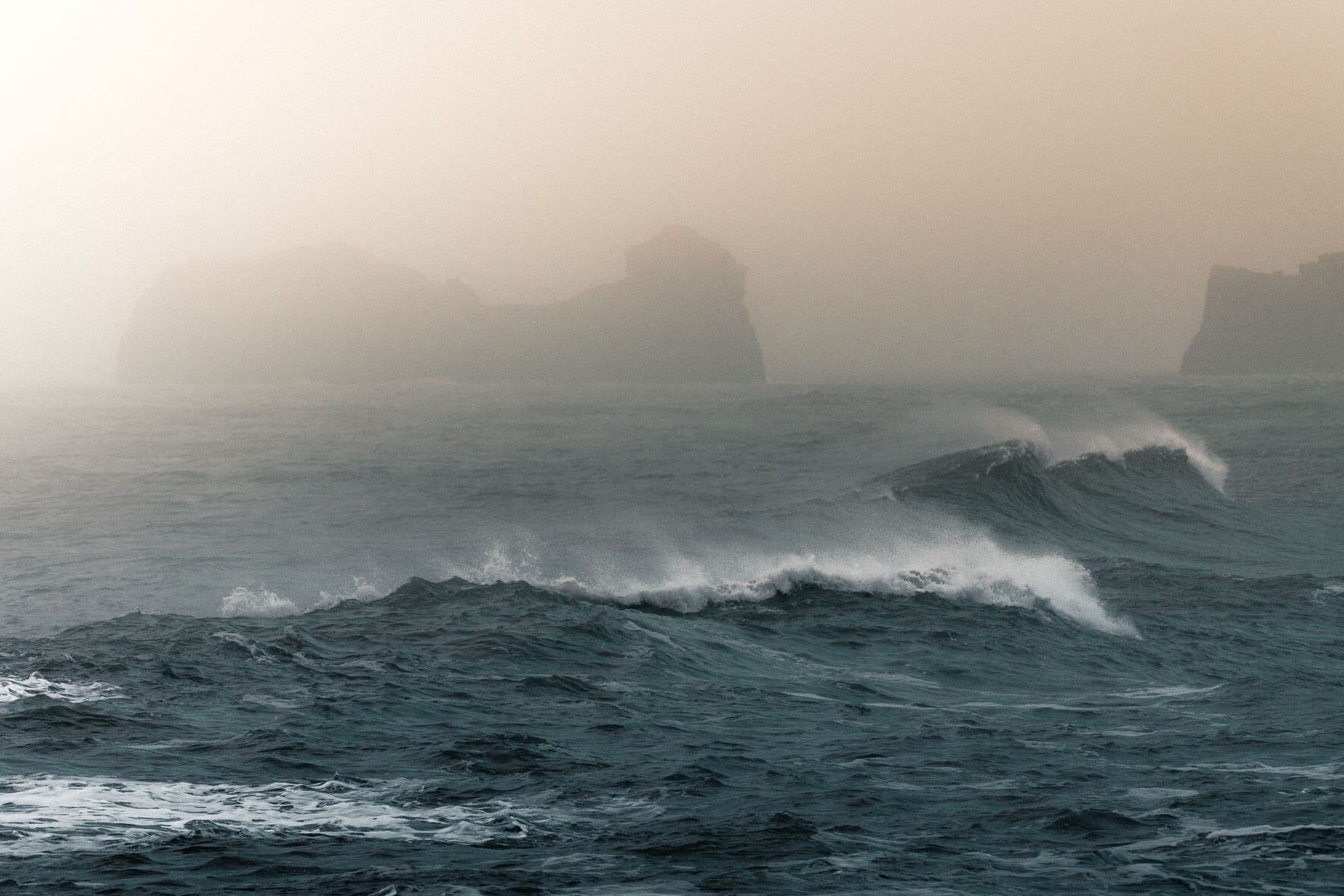 Sunrise over waves at Reynisfjara beach in Iceland