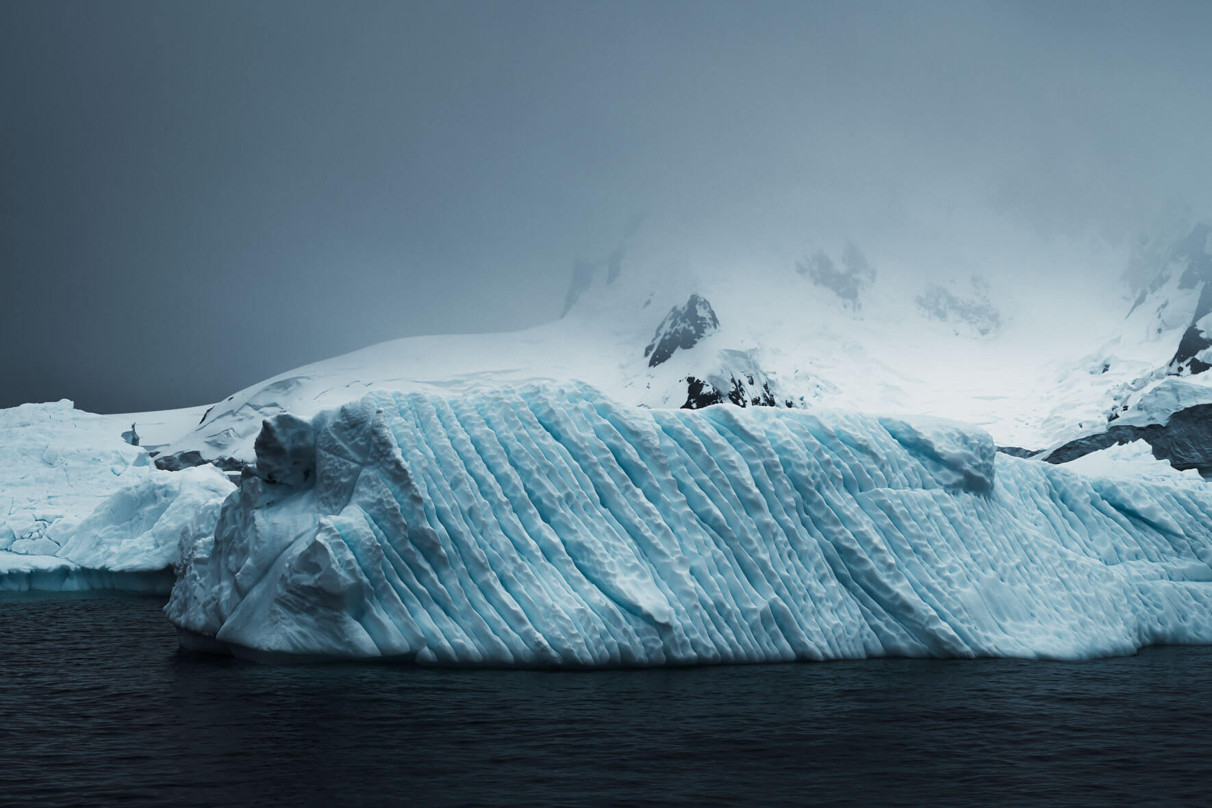 Iceberg in dark and dramatic weather on Antarctic Peninsula