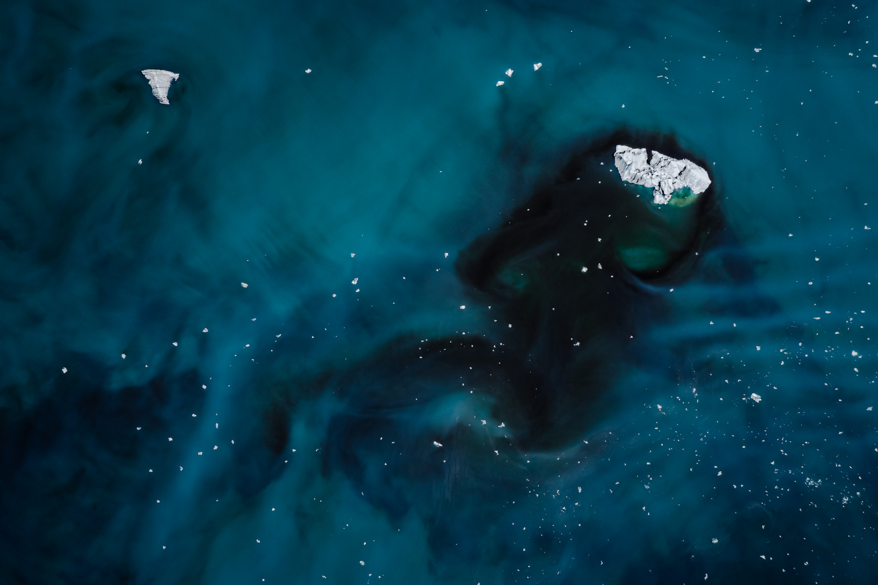 Aerial photography of iceberg floating in a glacier lagoon with dark water