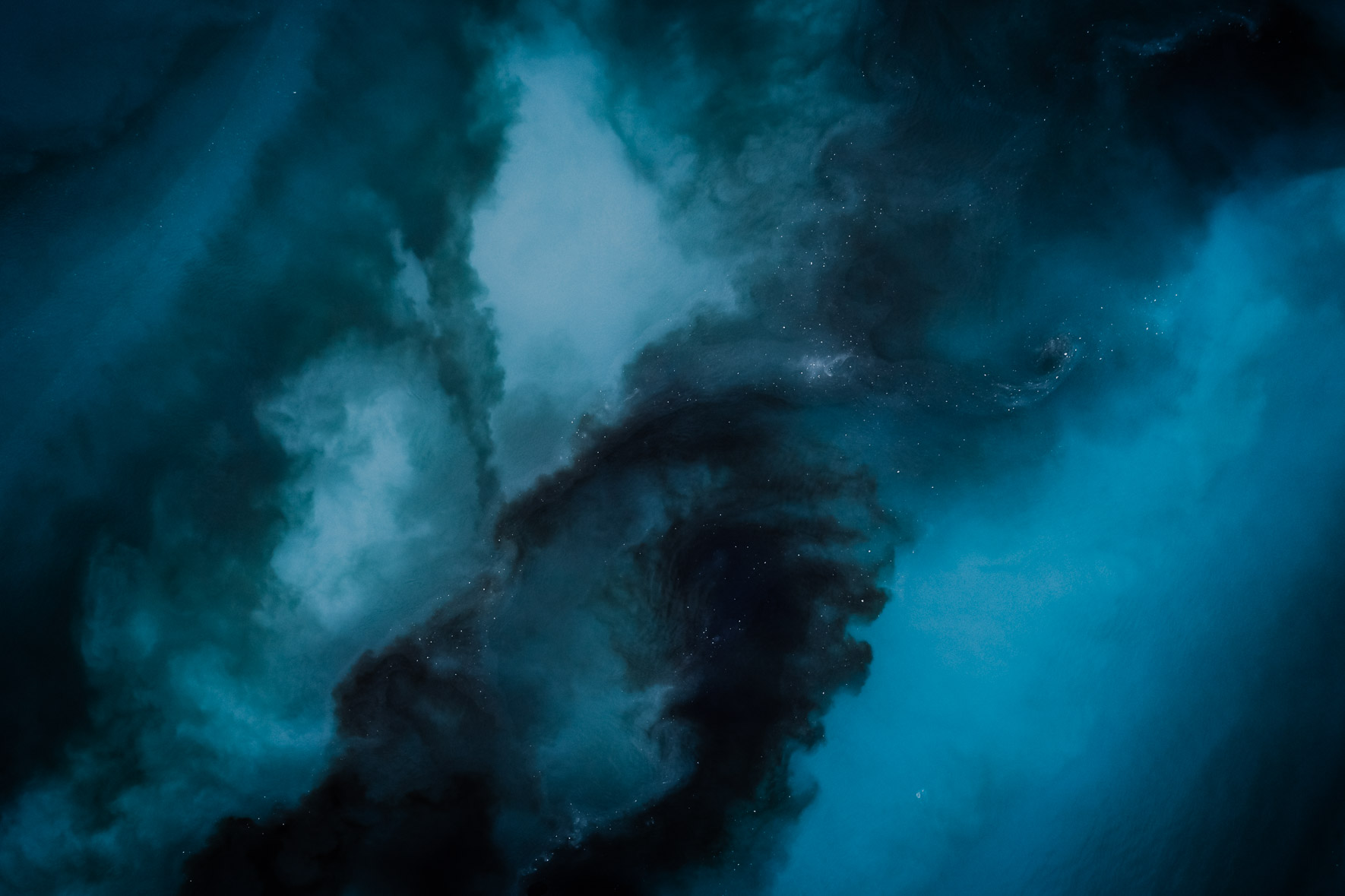 Aerial photography of dark blue water flowing in a glacier lagoon