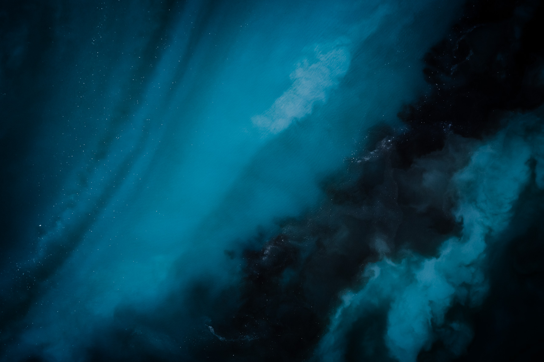 Aerial photography of dark blue water flowing in a glacier lagoon