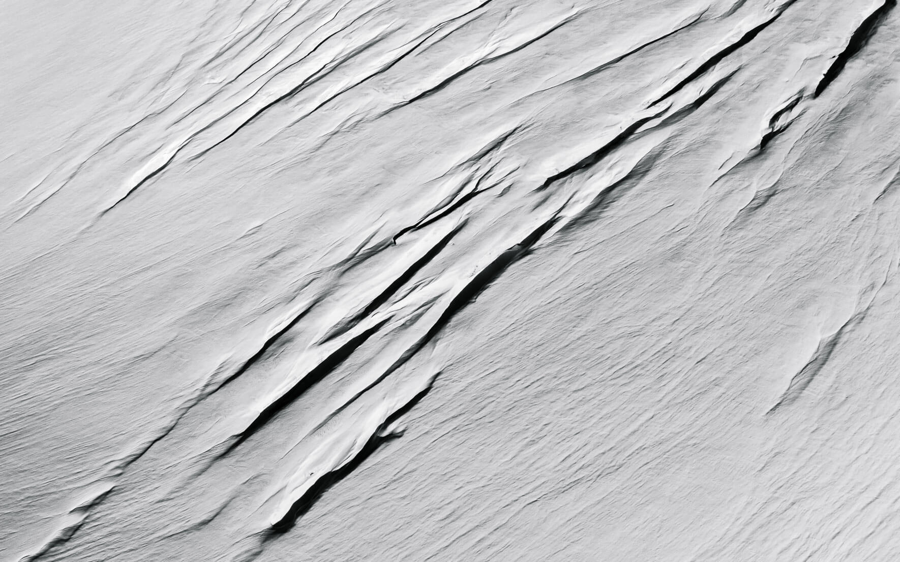 Glacial crevasses with snow in black and white