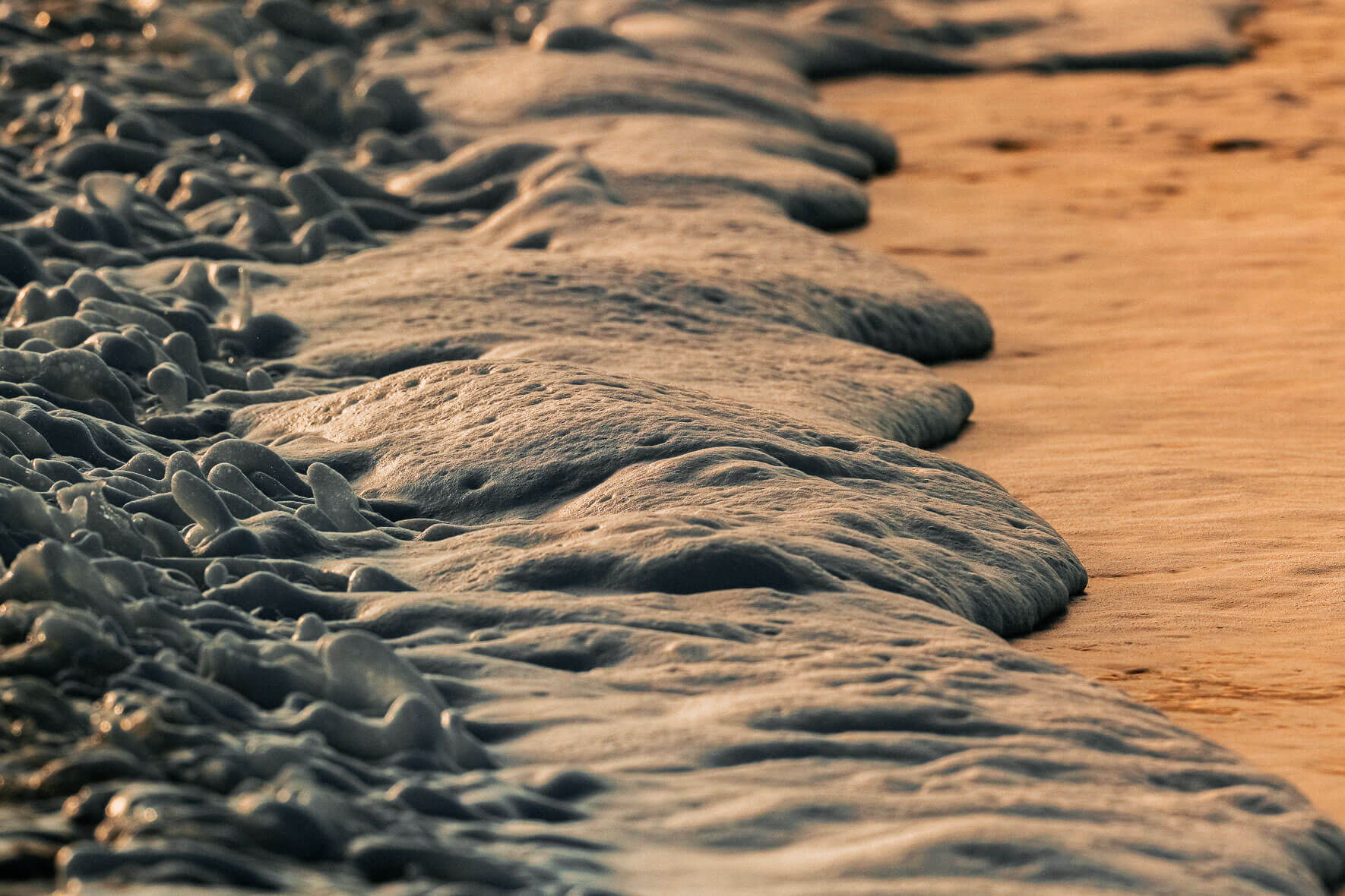 Waves on Black Sand Beach of Vík in Iceland during Sunset