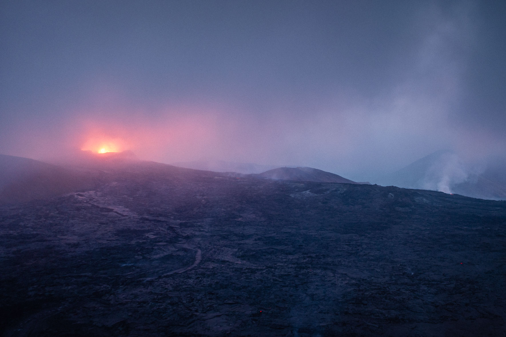 The crater of Fagradalsfjall volcano in Iceland in steam at night