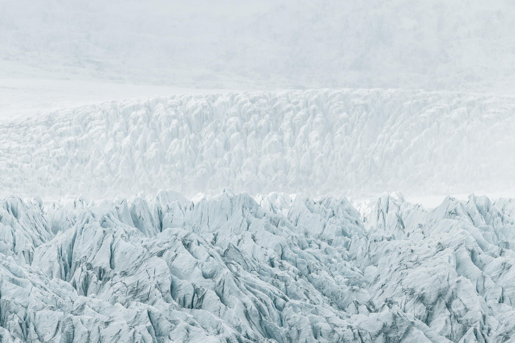 Fjallsárlón glacier in Iceland in bright sunlight with fog over the ice