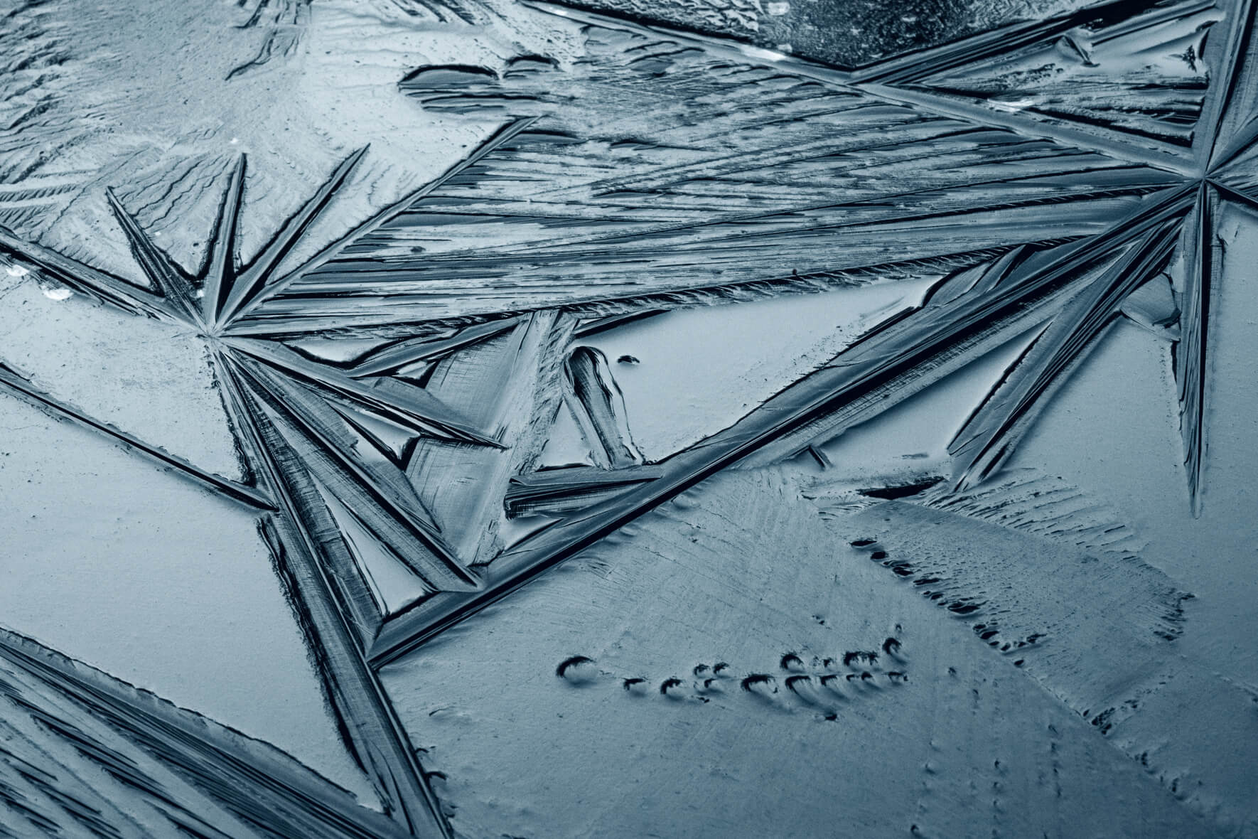 Abstract geometric lines and texture in the surface of a frozen lake