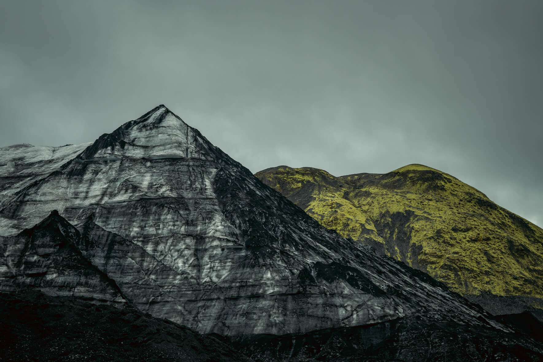 Dark glacier ice of Mýrdalsjökull in Iceland covered with sand and ash