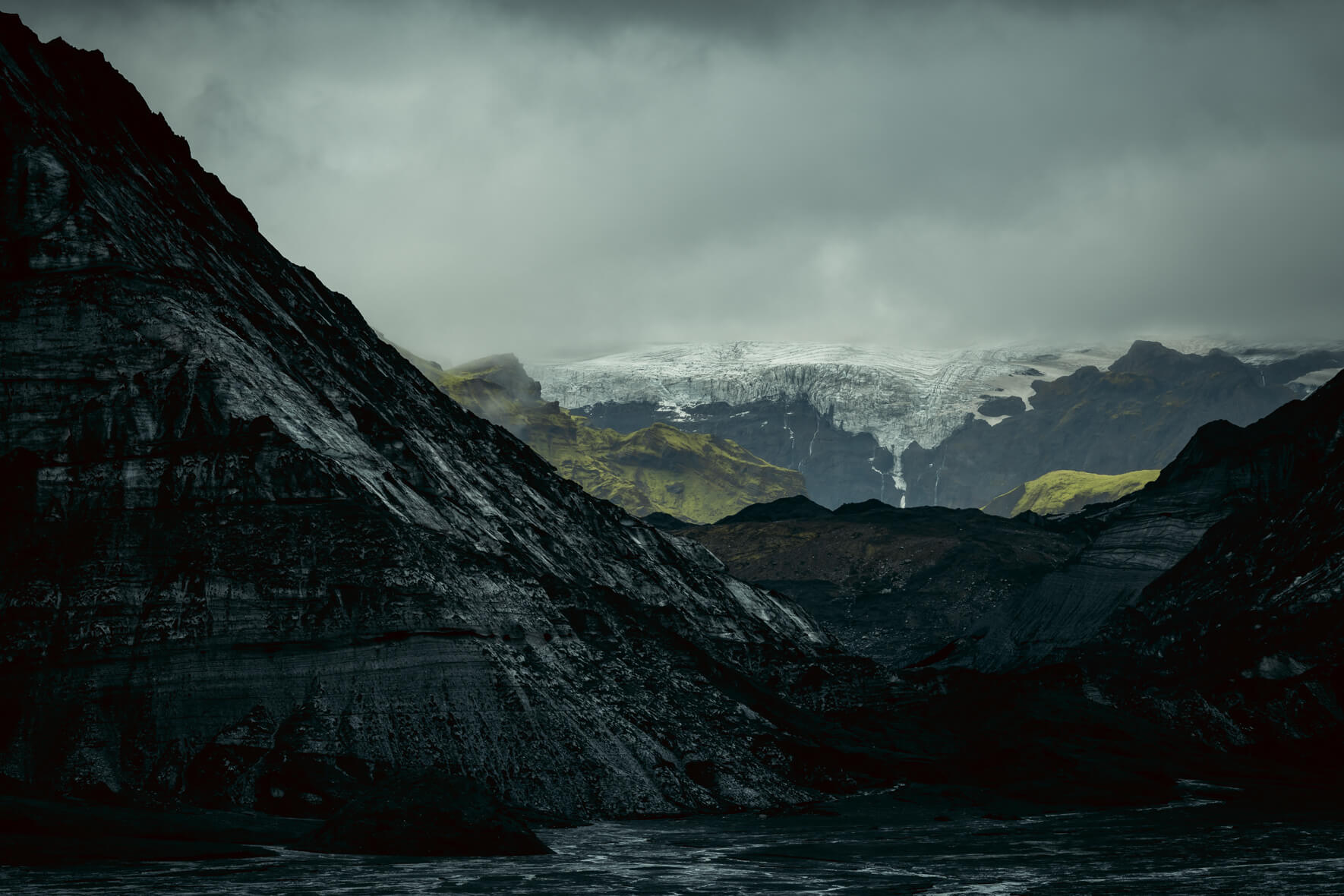 Kötlujökull glacier ice with dramatic weather and Mýrdalsjökull in the background