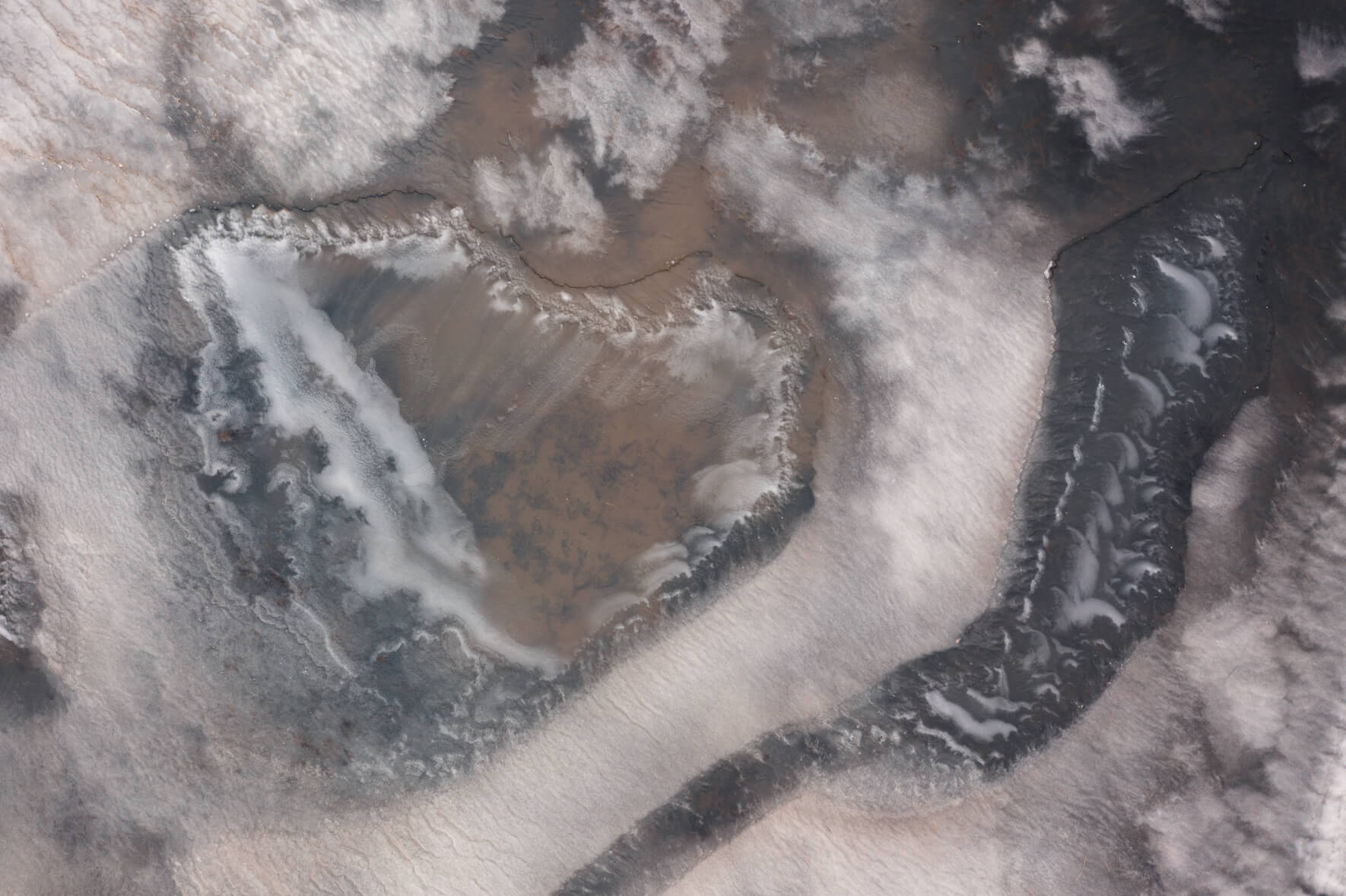 Aerial photo of a frozen pond on Jökuldalsheiði plateau in Iceland