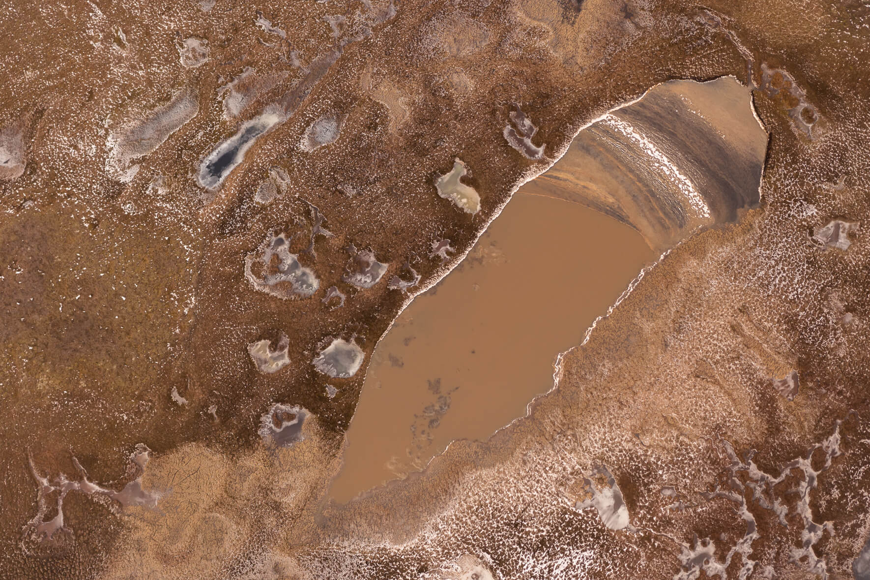 Colorful frozen ponds on Jökuldalsheiði plateau in eastern Iceland