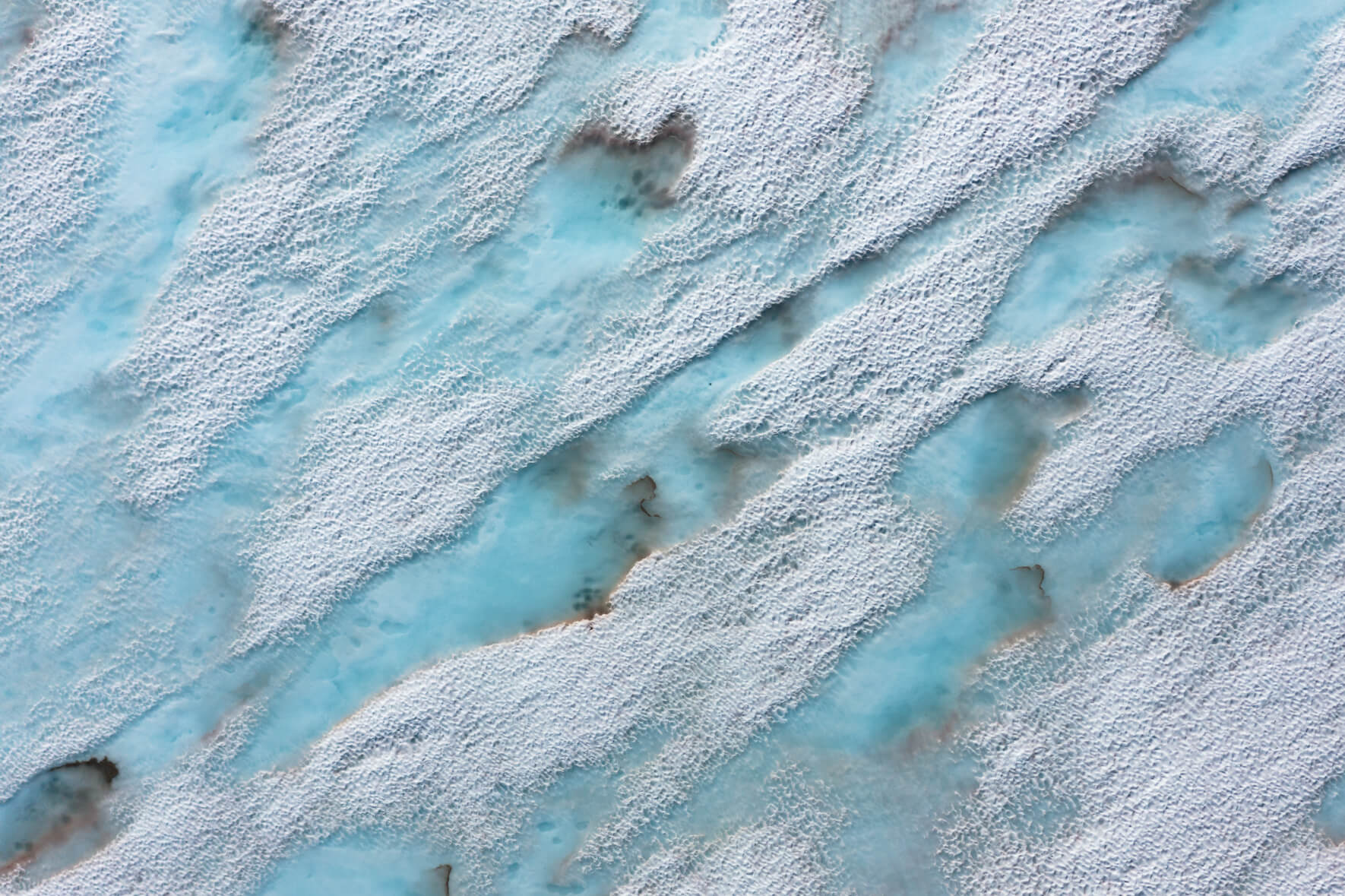 Meltwater lakes on a frozen lake in the mountains of Southern Norway