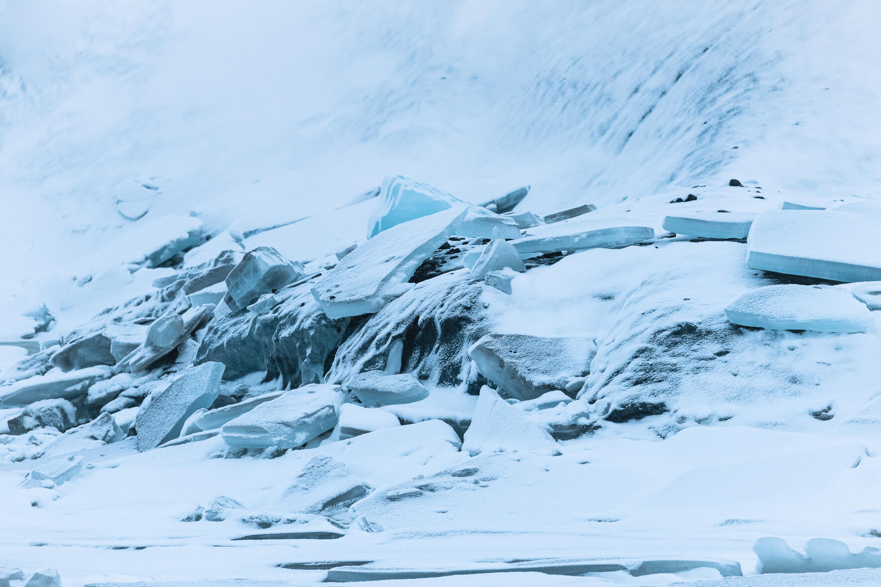 Ice plates from the frozen lake of Svínafellsjökull glacier in Iceland, covered with snow