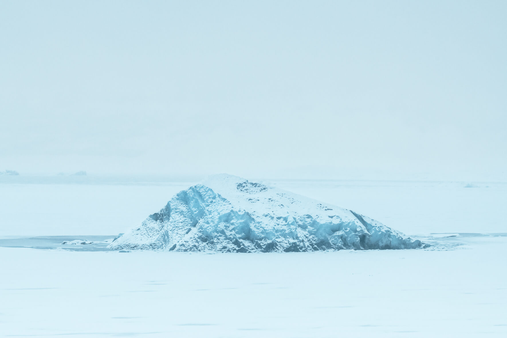 Lonely and snow covered iceberg in glacier lagoon Jökulsárlón