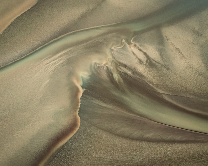 Dynamic tidal landscape in Alaska, where currents shape ever-changing coastal patterns