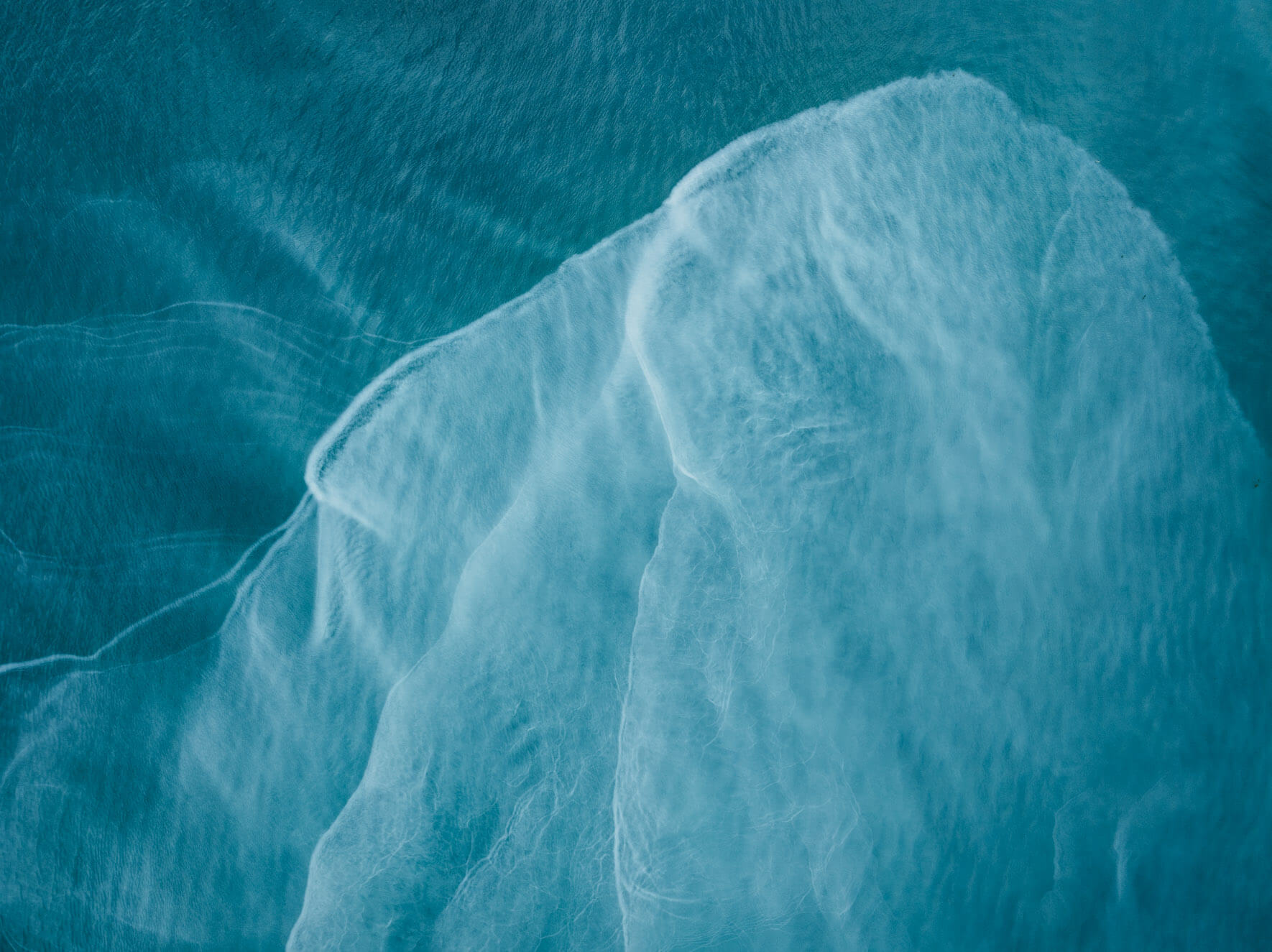 Glacial runoff in Kachemak Bay, Alaska, creating striking blue-green hues