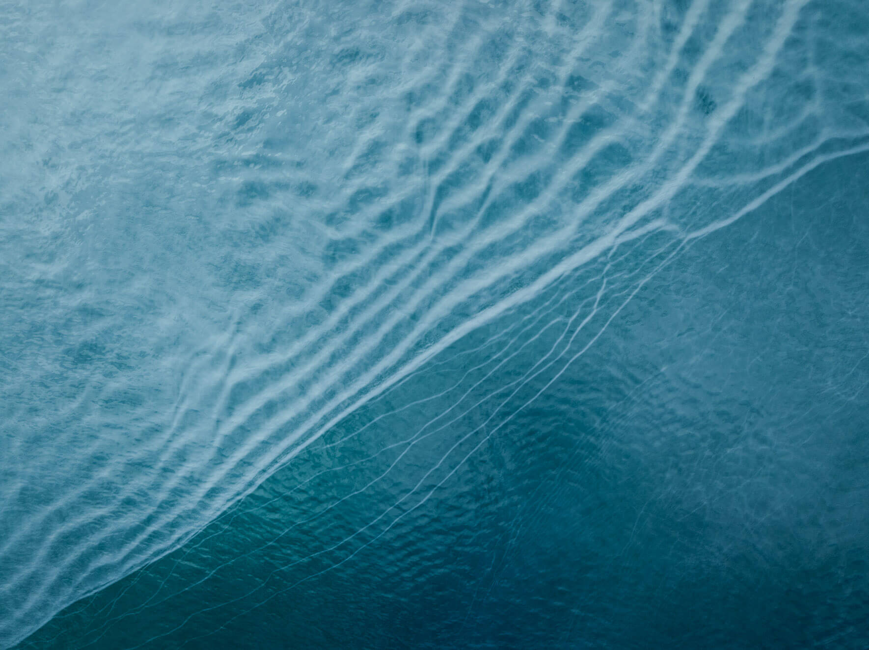 Glacial silt in Kachemak Bay, Alaska, blending into vivid shades of blue and green