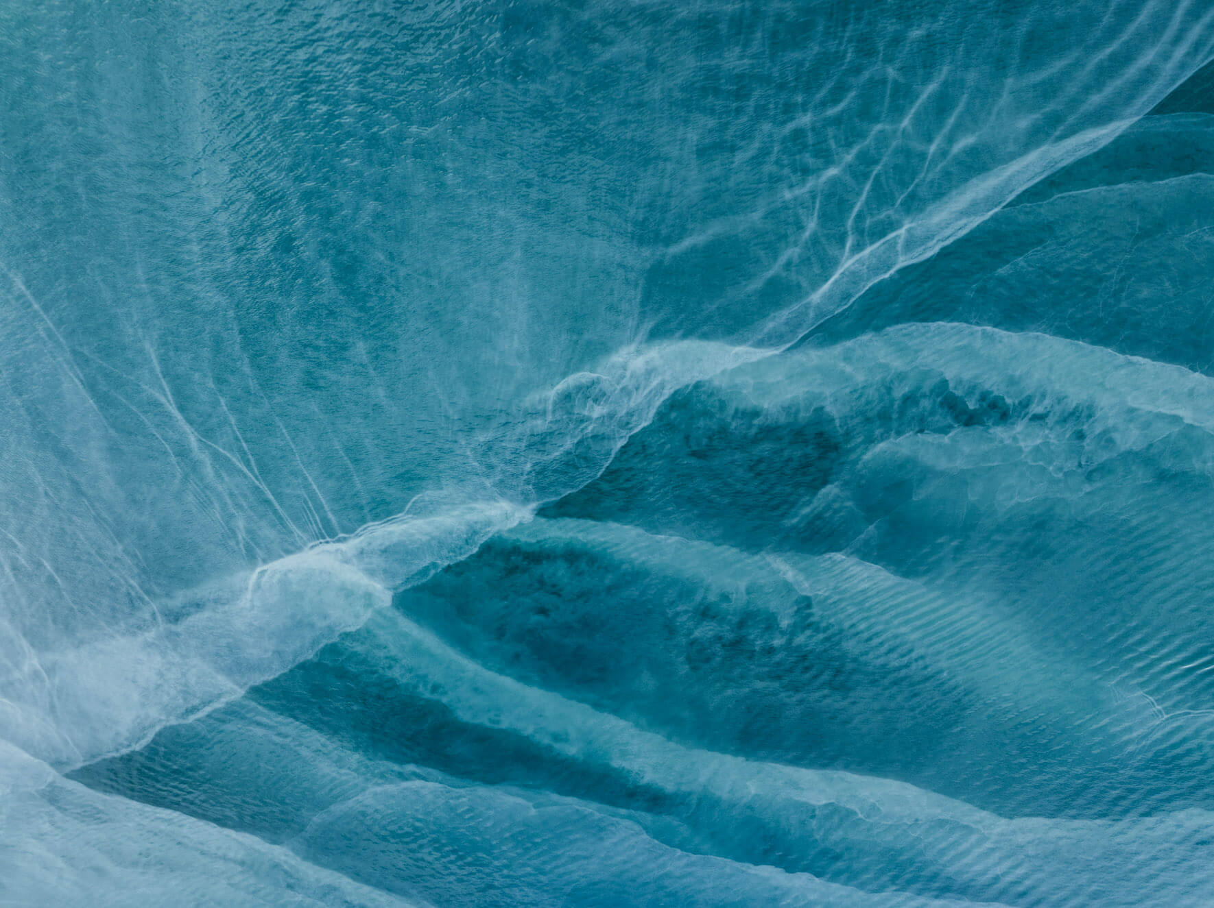 Aerial abstraction of Kachemak Bay (Alaska), where glacial minerals color the sea