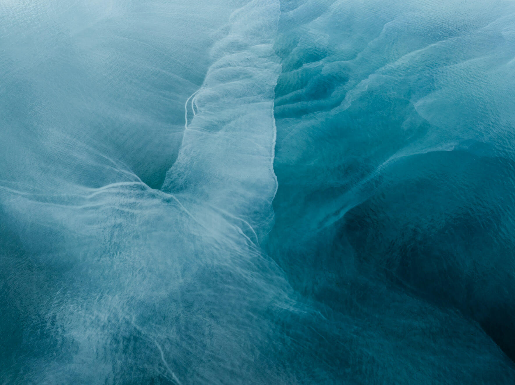 Vibrant coastal currents in Alaska, carrying glacial minerals through Kachemak Bay