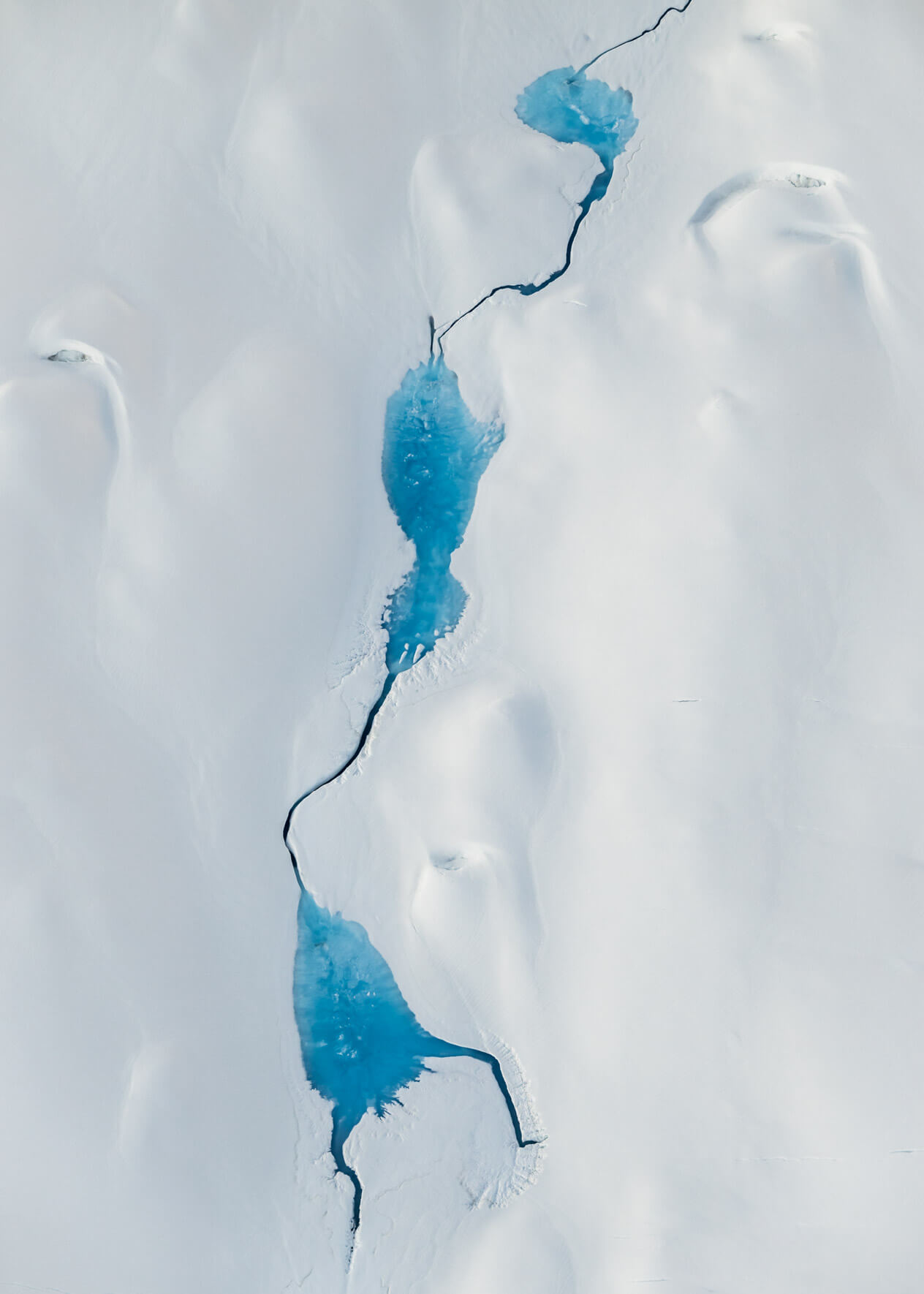 Aerial view of meltwater pools on Alaska’s rapidly retreating Columbia Glacier