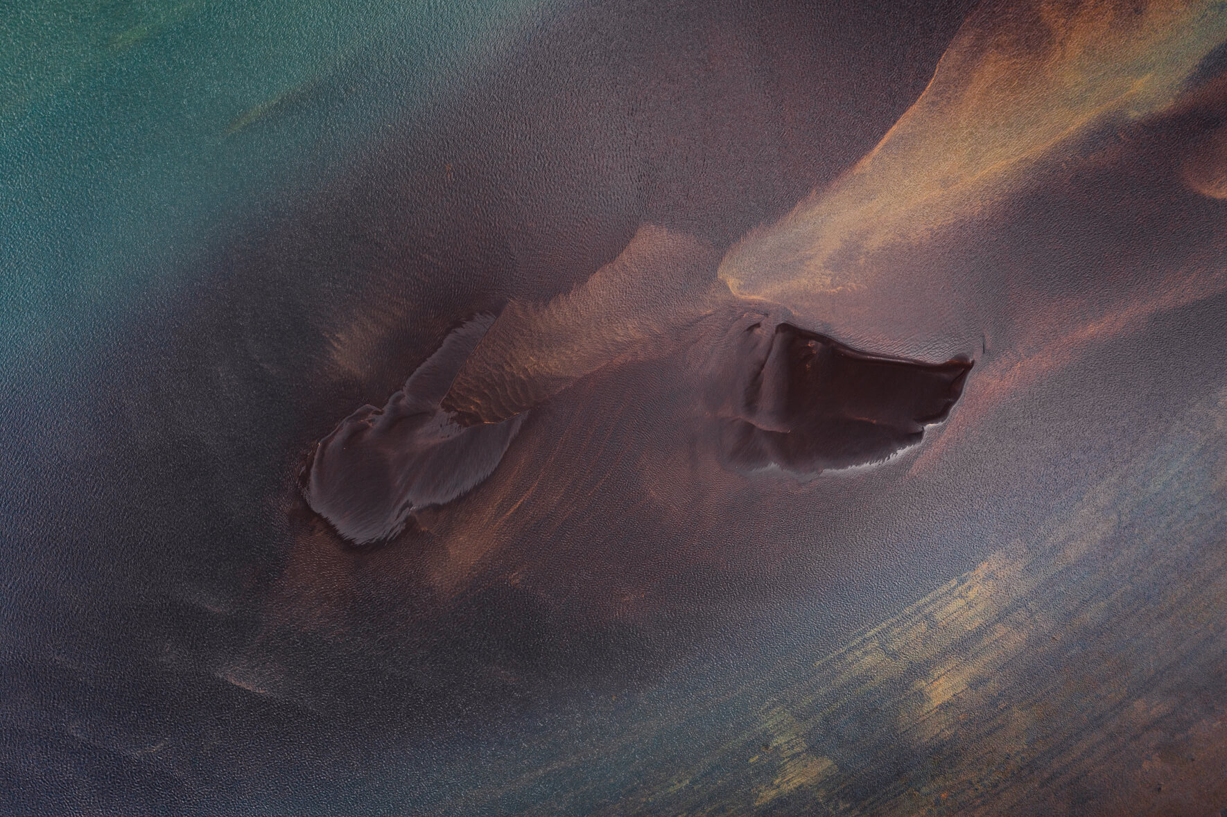 Colorful aerial view of a glacial river in Iceland with two sand islands in the middle