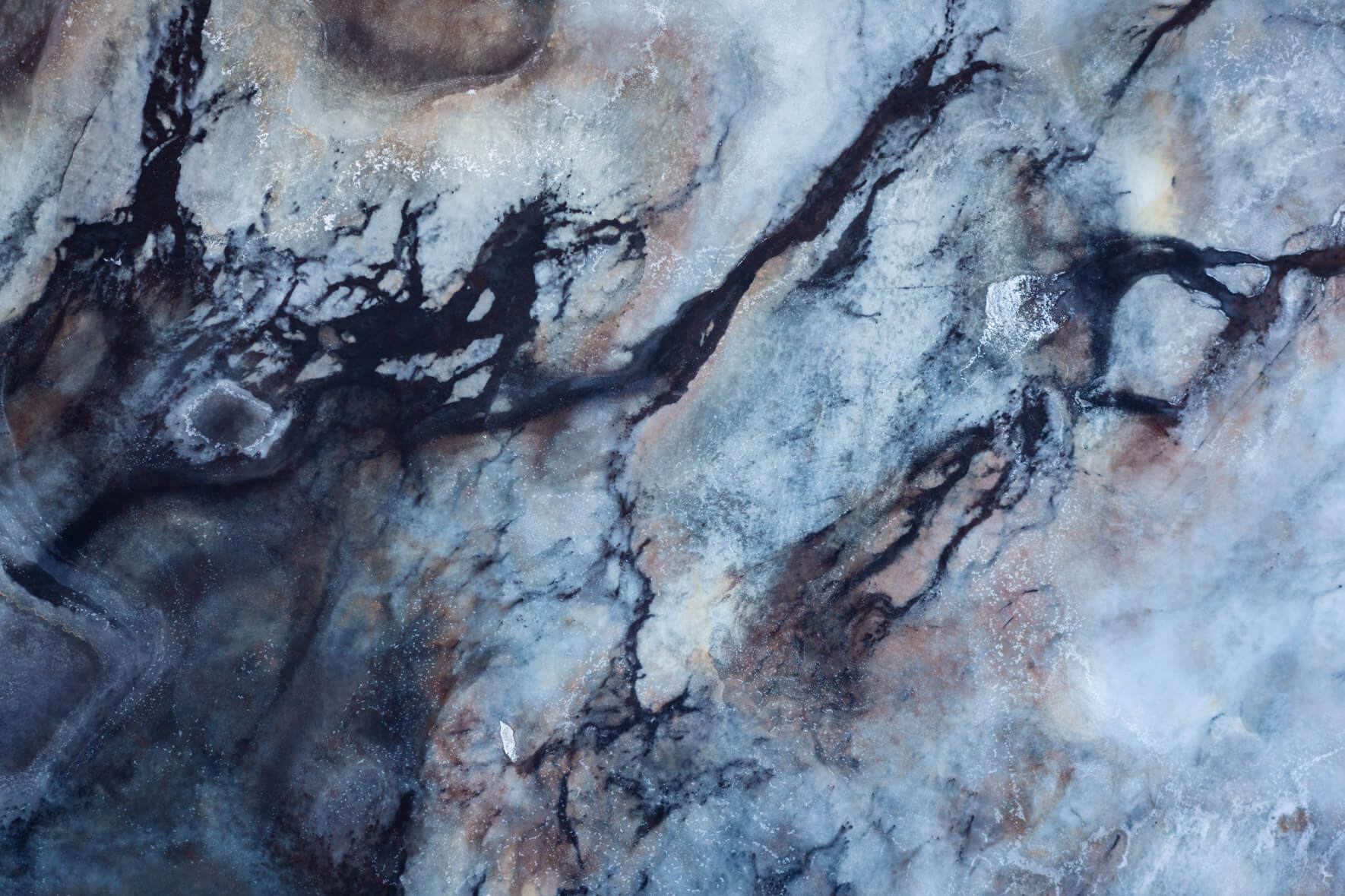 Frozen marshland formations in Iceland, displaying complex natural textures from above