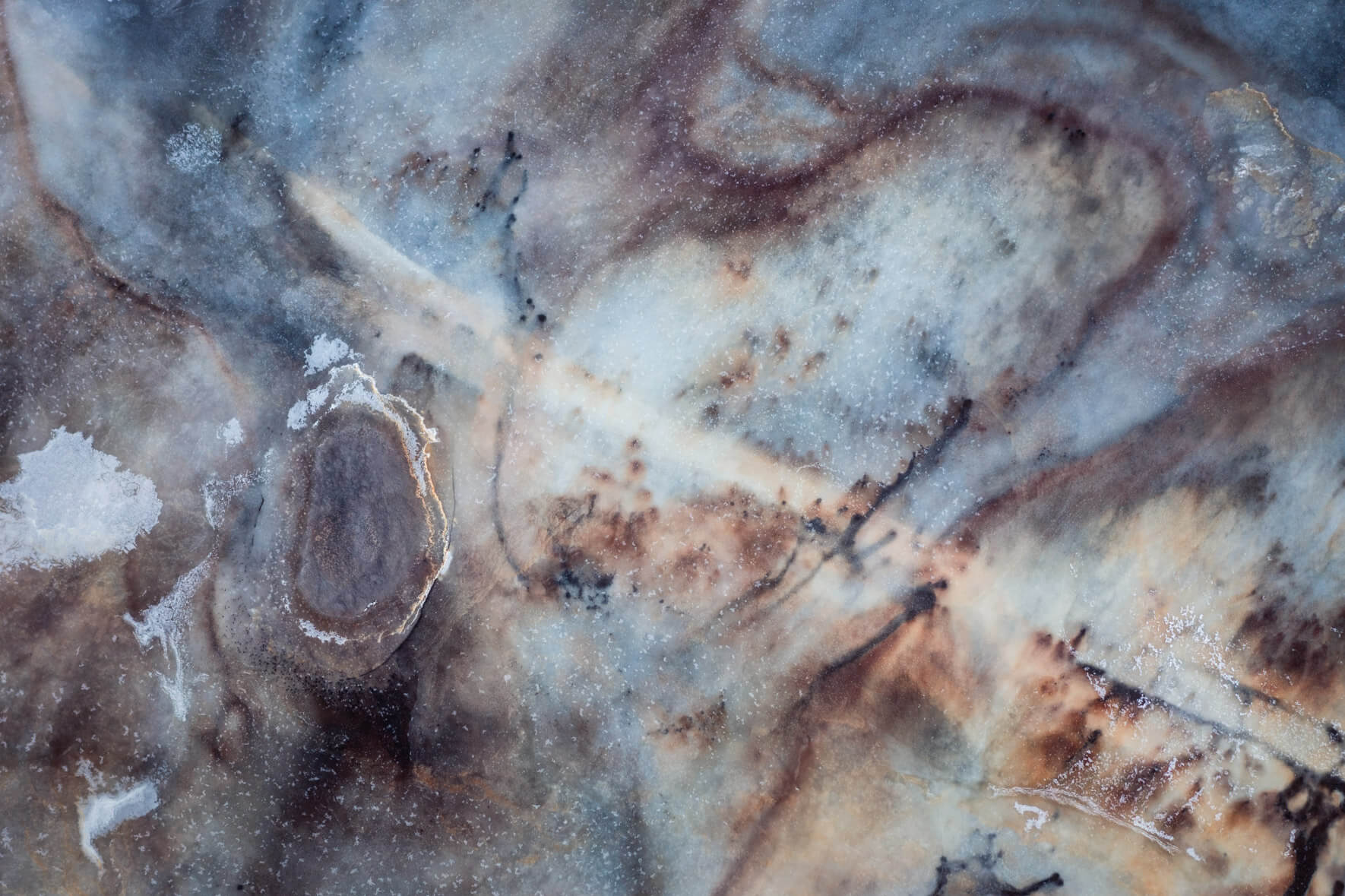 Aerial view of Iceland’s frozen marshlands, showcasing intricate ice patterns