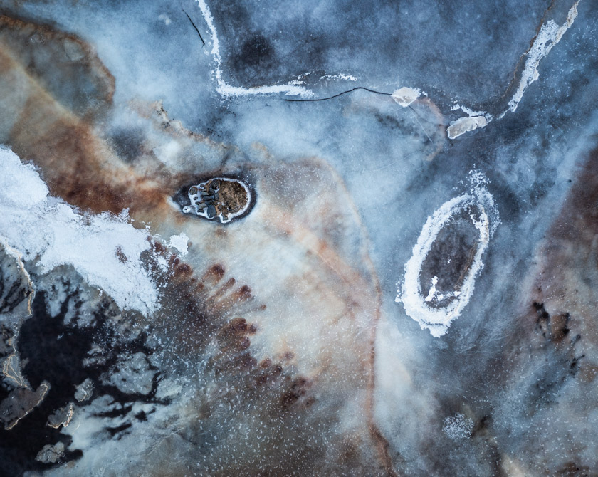 Textured frozen landscape in Iceland, with delicate ice formations and earthy tones