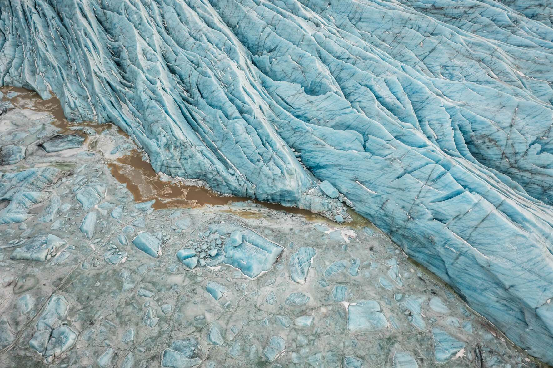 Aerial shot of Svínafellslón lagoon, highlighting the frozen surface shaped by Svínafellsjökull glacier