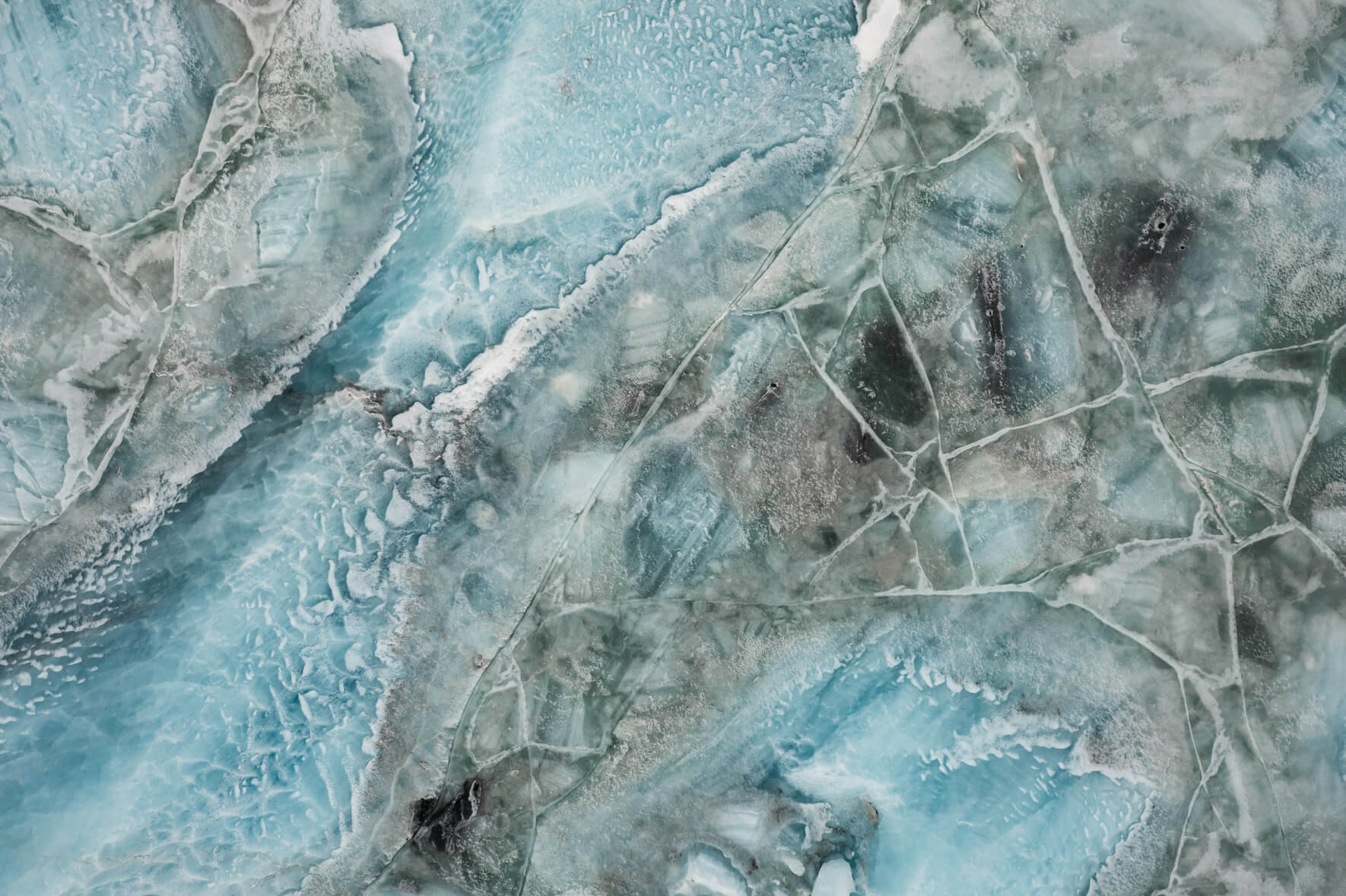 Svínafellslón lagoon in Iceland from an aerial perspective with cracked ice surface